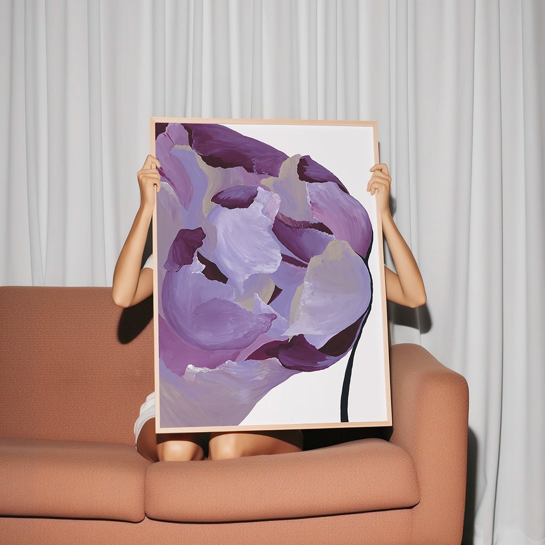 Woman holding large purple abstract painting with muted gold accents for eclectic interiors.